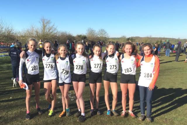 Charlotte Hilton (279) and Olivia Edwards (278) with the gold-medal winning Dr Challoners High junior girls team.