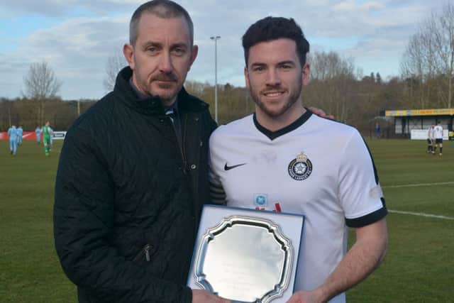 Kings Langley chairman Jeremy Wilkins presents Gary Connolly with an engraved plate to commemorate the defender's 200th appearance at the Slough match. (Picture by Chris Riddell)