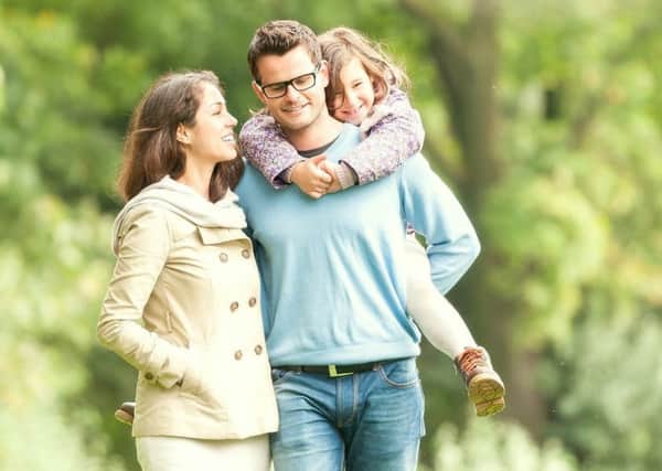 Young happy family of three having fun together outdoor. Pretty little daughter on her father back. Parents and girl look happy and smile. Happiness and harmony in family life. Family fun outside. PNL-151022-124456001