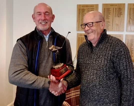 Left, David Dean, receives the John McDonough Cup from Little Hay GC seniors captain Paul Whiter.