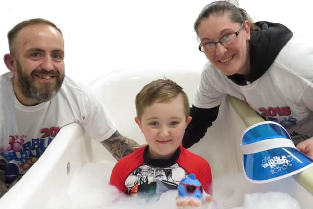 George Oliver with dad John and mum Kelly