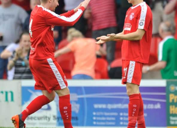 Jordan Parkes and Spencer McCall celebrate after the latter opened the scoring in The Tudors 3-0 win over Eastbourne Borough on Saturday which clinched a playoff place.