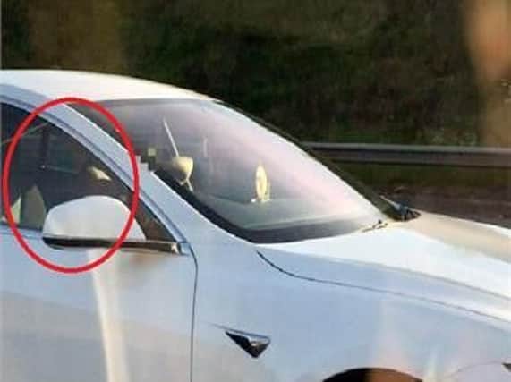 Patel, circled, was filmed sitting in the passenger seat