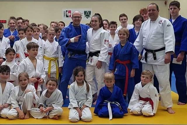 Emily Niven (16) with her Rush Judo team-mates celebrating her black-belt achievement.