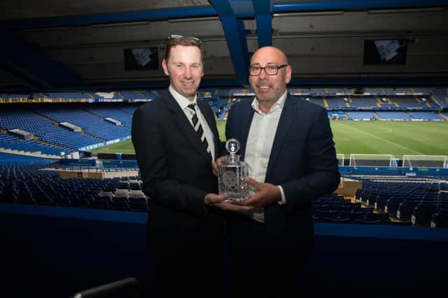 Kings Langley supporter Scott Robbins and director Darren Eliot with the award at Stamford Bridge, home of Premier League side Chelsea.