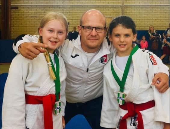 Rush Judo coach Laurie Rush with India Garman and Sophie May Rush.