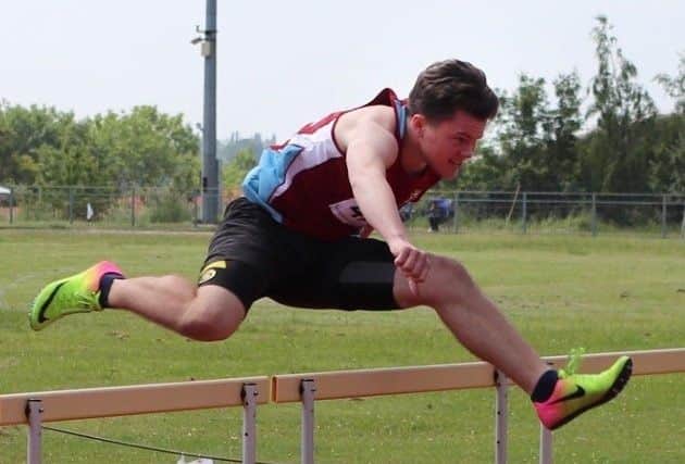 Ralph Williams competing in the 100m hurdles.