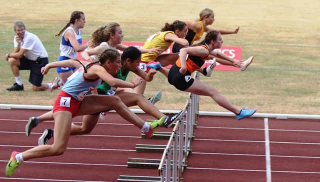 Mia McIntosh, leading in orange vest, won gold in the junior girls 75m hurdles.