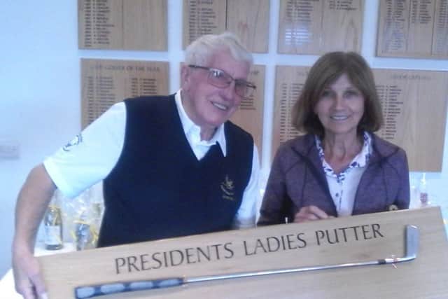 Club president Ralph Lane presents the ladies Presidents Putter  to  this years winner Margaret Flowers.