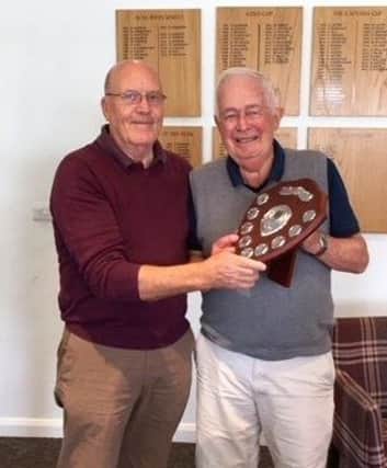 From left, Little Hay GC senior captain Paul Whiter presents John Poston with the Vic Allen Charity Shield