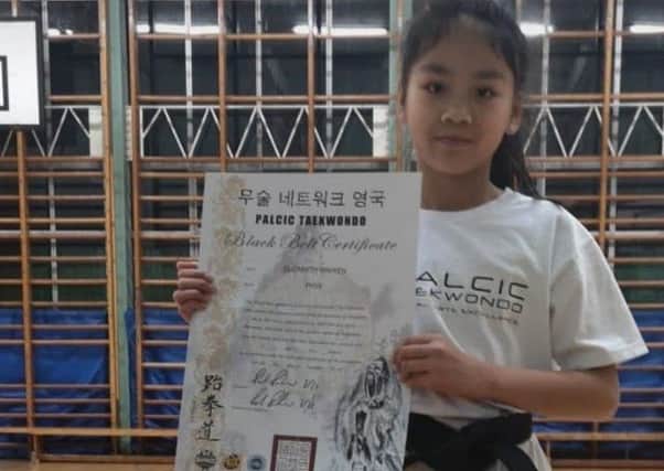 Elizabeth Nguyen with her ITF black-belt grading pass certificate at her Palcic Taekwondo Club base in Hemel.