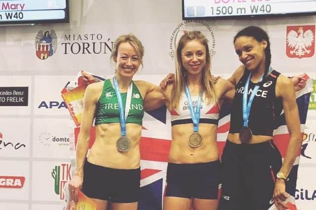 Zoe Doyle, centre, on the 1500m podium at the World Masters indoor championships in Poland.