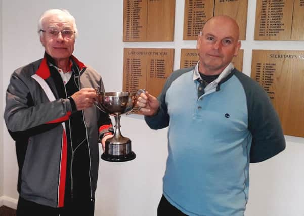 From left,  Trevor Sargent presents the Gold Cup to Mick Whelan at Little Hay GC on Saturday.