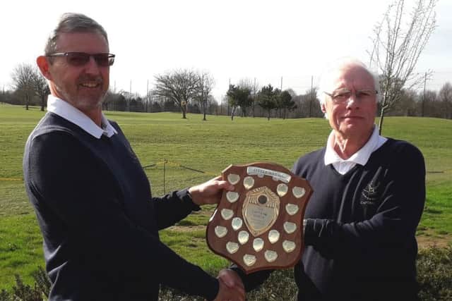 Paul Mudd, left, is handed back the Captains Shield by Trevor Sargent at Little Hay Golf Club.