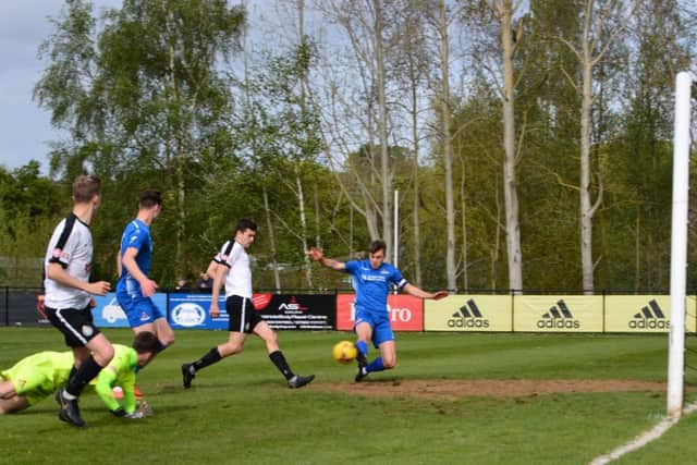 Mitchell Weiss finishes Kings second goal on Saturday against Frome Town. (Picture by Chris Riddell).