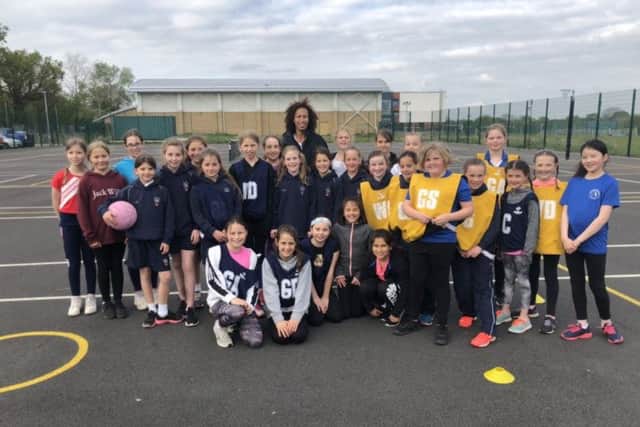 England international Serena Guthrie, back row, centre, visiting with youngsters from the Berko Belles team recently.