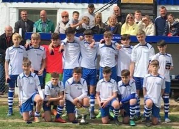 League Cup winners Tring Tornadoes Falcons under-14s with their trophy silverware and supporters at Marlow FC earlier this month.