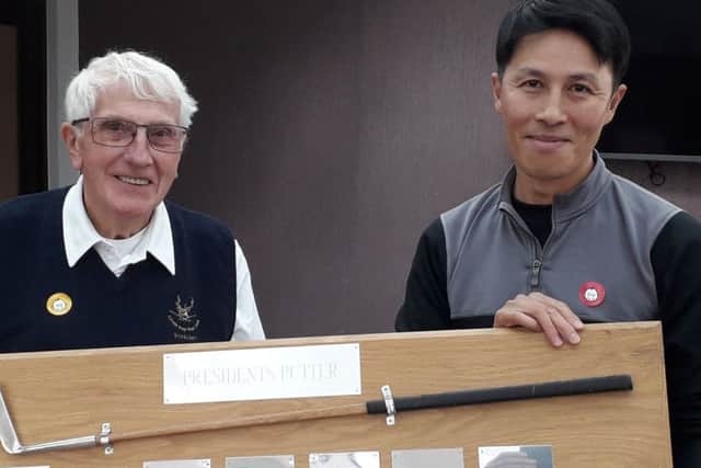 From left, Little Hay Golf Club President Ralph Lane presents Tong Tse with the Presidents Putter, which Tong has now won for three years on the trot.