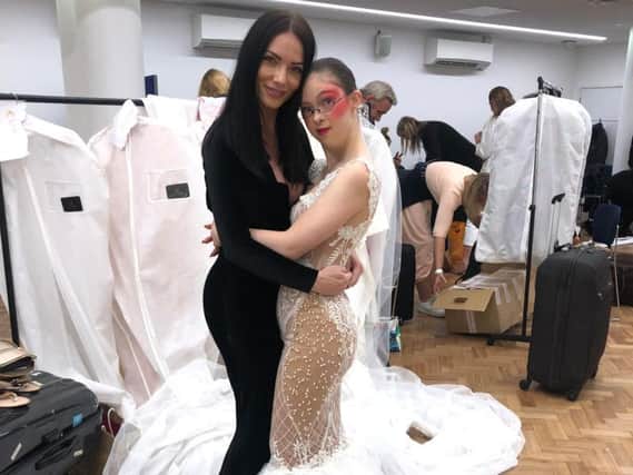 April Banbury pictured with one of her models at London Fashion Week