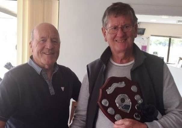 From left, Paul Whiter presents Edward Theobald with the Vic Allen Charity Shield at Little Hay Golf Club after his card play-off victory last Tuesday.