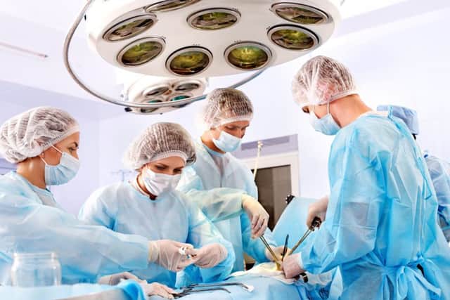 Team surgeon at work in operating room. PPP-141119-162832001