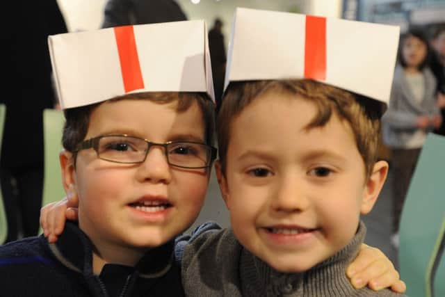 Samuel Dunbar three, left, and brother Kyle, five, wearing papermakers' hats.