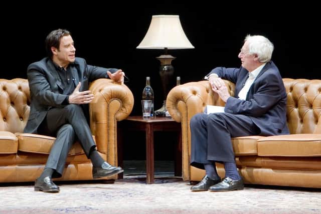 John Travolta in conversation. Photo supplied by WENN