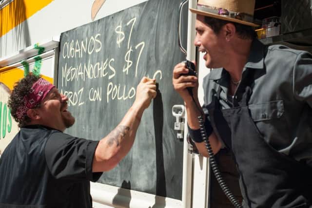 Jon Favreau chalks up the daily specials in Chef