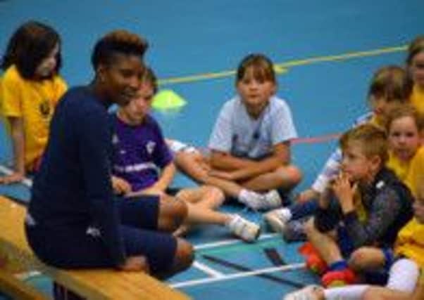 Denise Lewis meets with children during a summer sports camp at Berkhamsted School