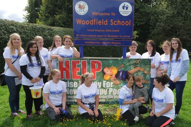 Supporters arrive at Woodfield School, Leverstock Green, after walking from Northchurch to raise funds to improve the school therapy pool. Sarah Bedford is holding her daughter Ella, aged 4