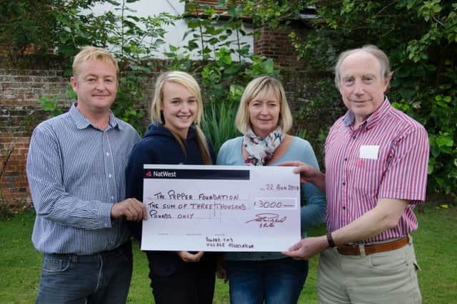 Eric Pillinger (right) receiving a cheque for £3,000 from Bourne End Village Associations Sally, Sophie and Ian Gibbs