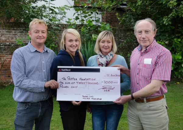 Eric Pillinger (right) receiving a cheque for £3,000 from Bourne End Village Associations Sally, Sophie and Ian Gibbs
