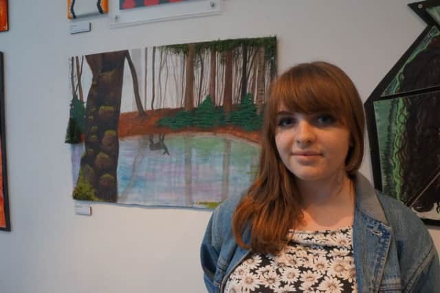 Isabelle Holland showcasing her artwork