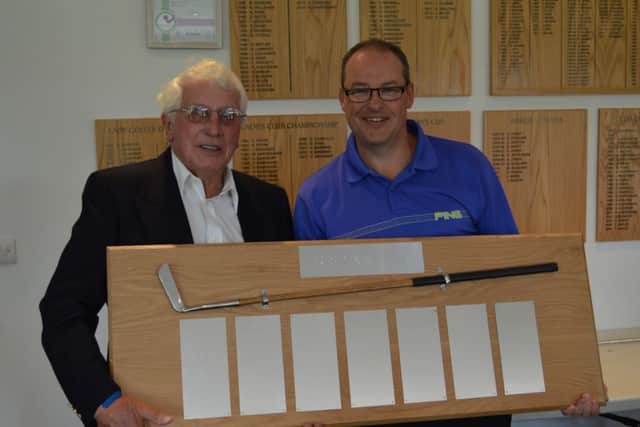 Phil Jefferson receives the Presidents Putter Trophy from Little Hay club president Ralph Lane