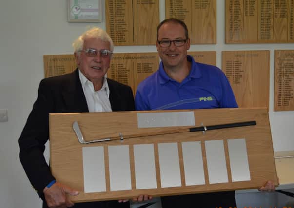 Phil Jefferson receives the Presidents Putter Trophy from Little Hay club president Ralph Lane