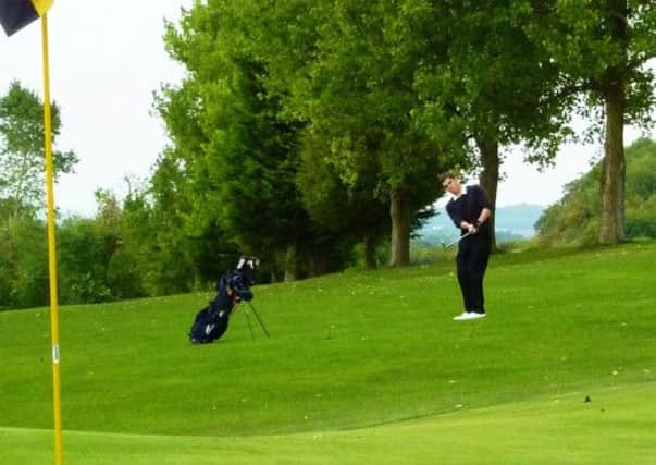 Brandon Black chips onto the 18th green on his way to victory in the Club Championship at Ivinghoe Golf Club