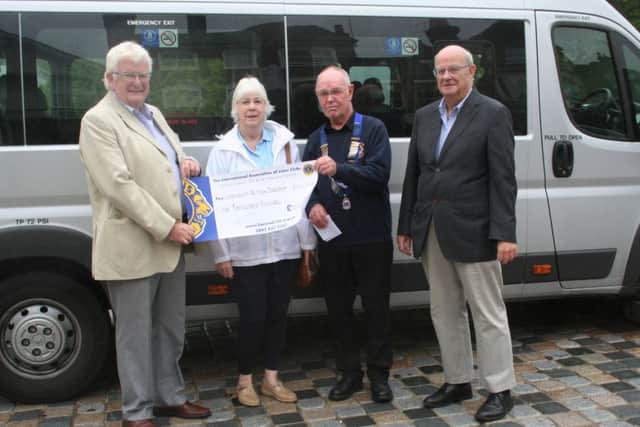 Community Action Dacorum receiving a £1,000 cheque from the Hemel Hempstead Lions Club