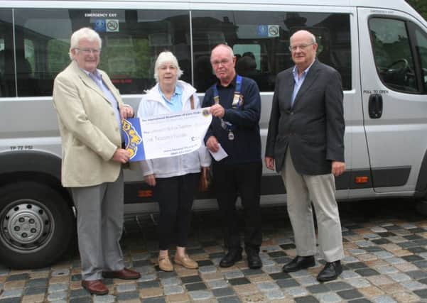 Community Action Dacorum receiving a £1,000 cheque from the Hemel Hempstead Lions Club