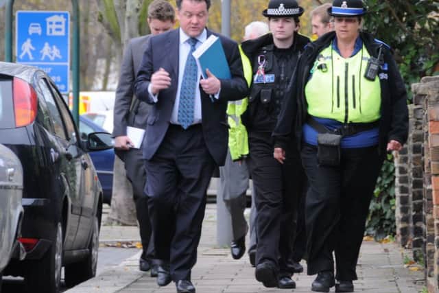 Herts police and crime commissioner David Lloyd walking with police officers