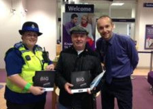 Natwest branch manager Darren Guy and PCSO Carlene Street give tips to customers including Reginald Stickings on how they can prevent themselves from becoming victims of scams