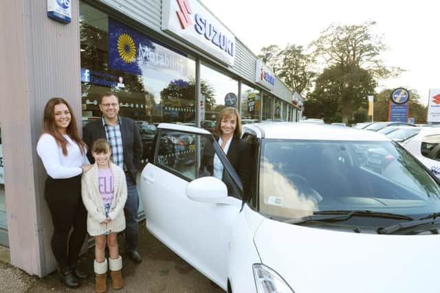 The Dear family collect their prize from Anthony Betts in Hemel Hempstead