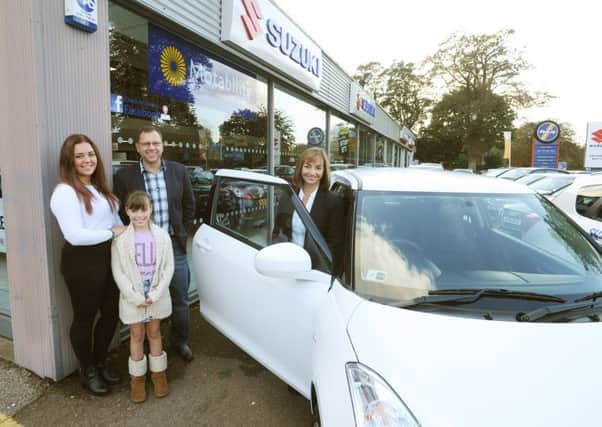 The Dear family collect their prize from Anthony Betts in Hemel Hempstead