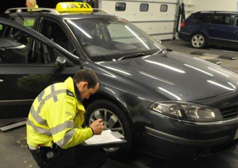 Police taxi checks - stock image