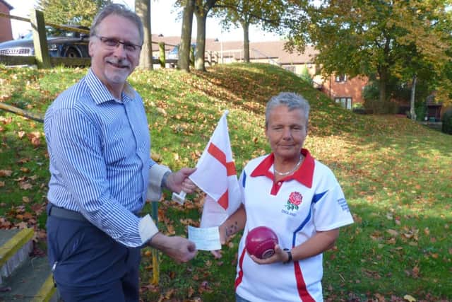 Blind bowls player Sarah Marshall receives a cheque from Graham Harris of the Rotary Club of Berkhamsted