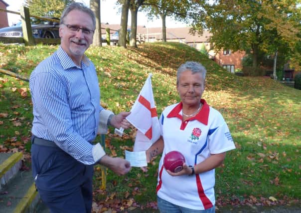 Blind bowls player Sarah Marshall receives a cheque from Graham Harris of the Rotary Club of Berkhamsted