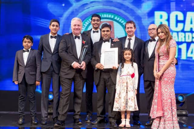 Tahir Ullah Khan of Saffron receives his award at the Bangladeshi Caterers Association, with Mike Penning