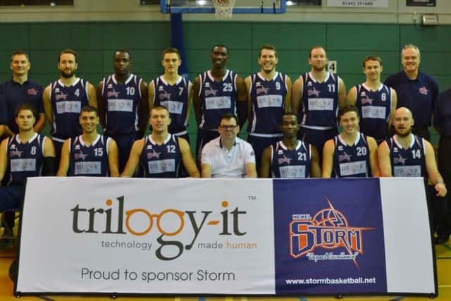 Phil Macleod (front row, fourth from left), with the Storm senior squad players, coaches and physio.