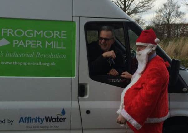 Frogmore visitor services manager Peter Burford receives the keys for the new van from Santa at Affinity Water