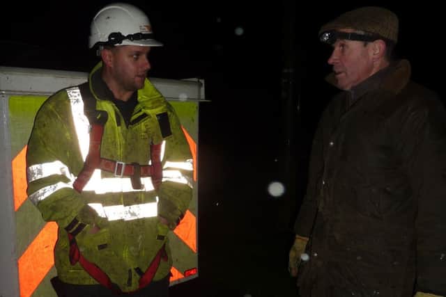Electrician Justin chats with farmer Geoff Brunt during the storms
