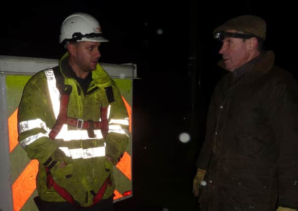 Electrician Justin chats with farmer Geoff Brunt during the storms